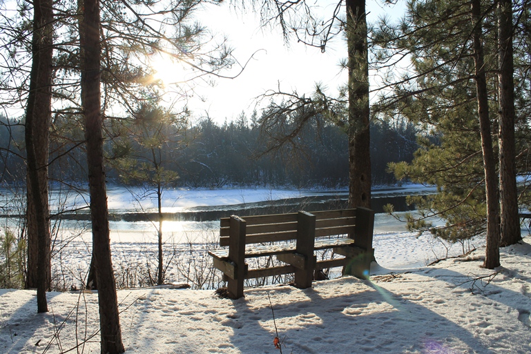 A bench overlooks the partially frozen waters of the Namekagon River in this image. NPS photo.