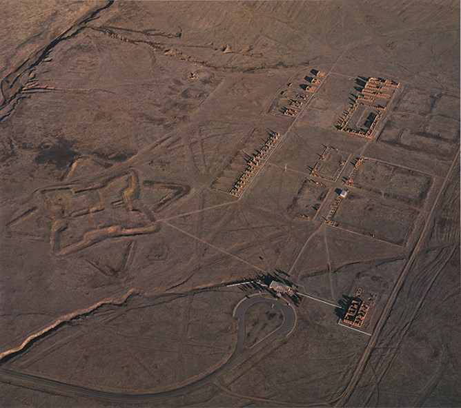 view from high above showing the outlines of structures or ruins on the ground