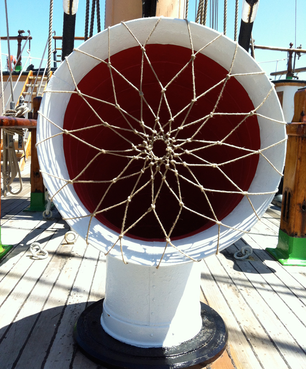 A cowl vent on BALCLUTHA with netting made out of rope stretched across the opening.