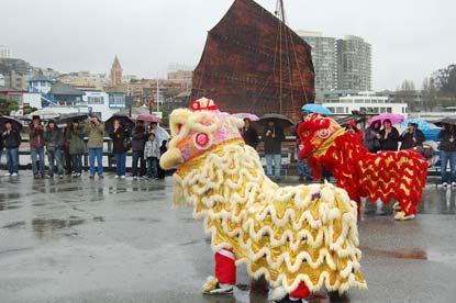 Two lions dance on Hyde Street Pier.