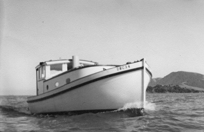 A motor-powered wooden boat moving through the water.