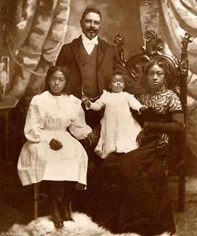 A formal portrait of Captain Shorey with his wife and two children.