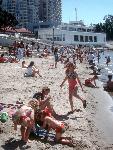 Visitors enjoying warm weather on the beach.