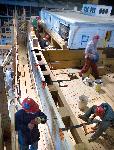 Shipwrights working on the deck of Thayer.