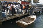 Student launch boat from dock into the water.