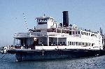 300 foot long white wooden ferry at the pier.