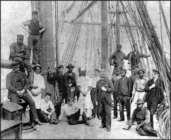 Group of seafaring men posing on the main deck of a 19th century sailing ship. SAFR K9.28,157