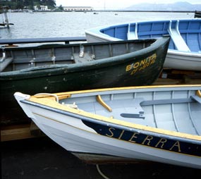 The bow sections of three wooden boats.