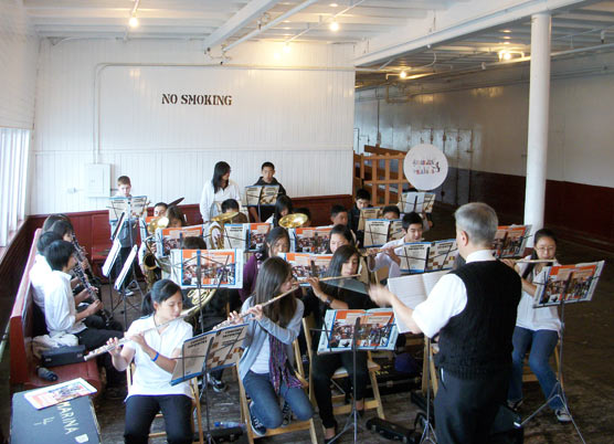 High school band playing on a ferryboat.