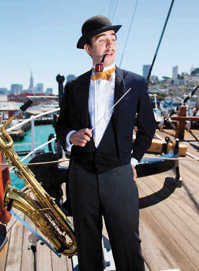 A man standing on the foredeck of the BALCLUTHA holding a baton.