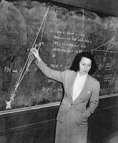 A woman standing in front of a chalkboard.
