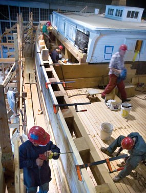 Five men working on the main deck and bulwarks of the CA Thayer.