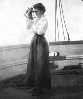 A woman on the deck of a ship at sea taking a sight with a sextant.