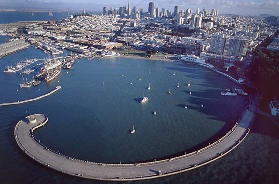 An aerial view of San Francisco Maritime National Historical Park with downtown San Francisco in the background.