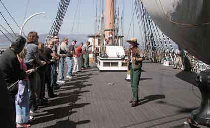 Visitors raising the staysail on Balclutha.