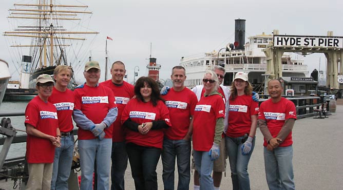 A group of people standing together on Hyde Street Pier.
