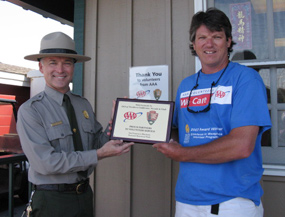 Park superintendent presenting an award to a volunteer.