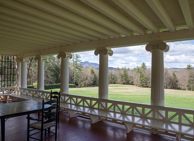 porch with columns and view of mountain in distance