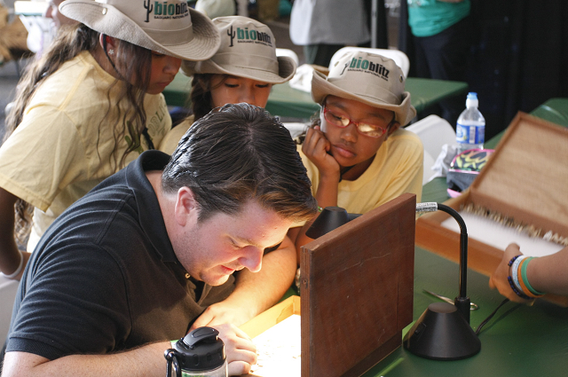 Scientist Chris Grinter going through specimens with Electronic Field Trip students