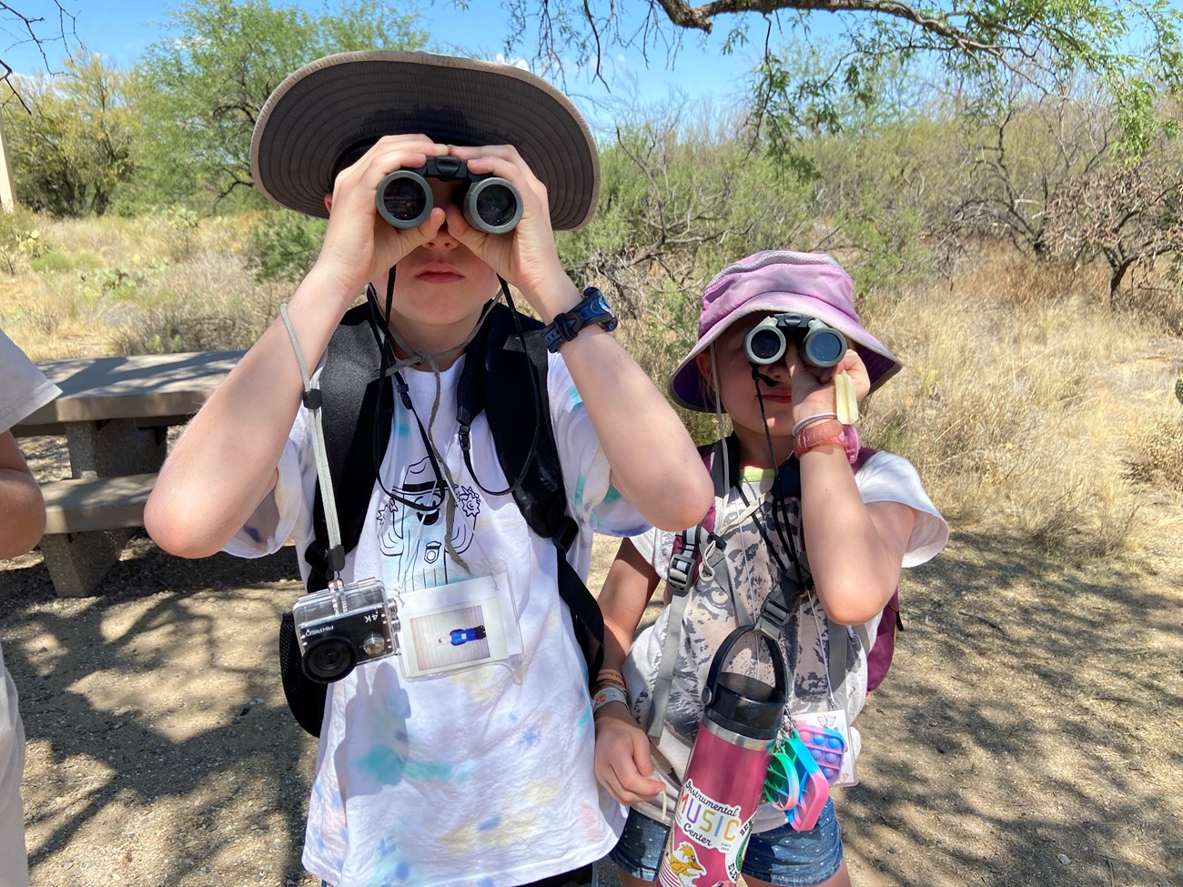 kids look through binoculars at the camera