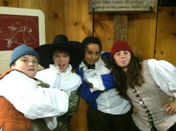 School children in costumes roleplaying owners and workers