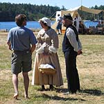 Re-enactors Roger Ellison and Anita Barreca orient a visitor during the August Encampment at English Camp.