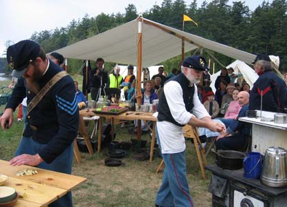Michael Murphy (left) and Oren Combs race to contact a 19th century meal during Encampment's annual Cast Iron Cookoff, one of the most popular events in Encampment's 10-year history.