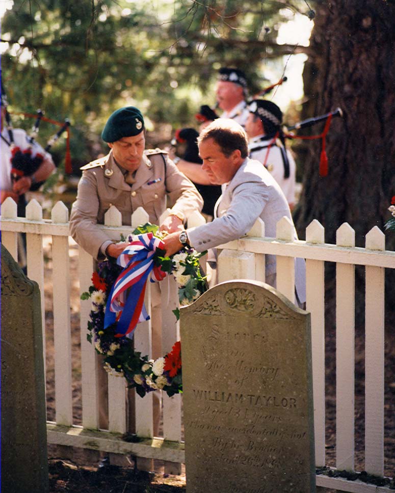 Lt.Col. Hank de Jager, RM, and British Counsel Mike Upton lay a wreathe at the Royal Marine cemetery. Five Royal Marines are interred and one memorialized in the fenced plot on the slope of Young Hill.