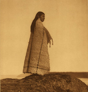A Cowichan girl standing on a rock. A Cowichan girl standing on a rock.