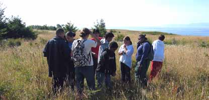 A group of middle school students enjoy a hike on American Camp's sweeping prairie.