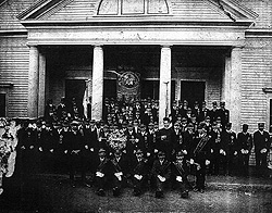 Members of the St. Joseph Society on the steps of the old wooden Polish Catholic Church.