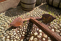 An old anchor sits on the cobblestones outside the Bonded Warehouse