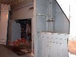 the small kitchen contains a fireplace and sink
