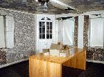 a small room with large windows & elegant woodwork