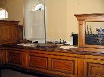 The Public Office has wooden counters and desks.