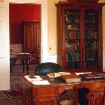 the private office has a desk and a bookcase
