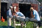 NPS volunteers demonstrate furling a sail