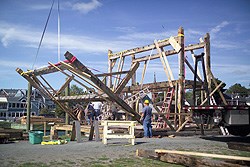 timber frames being raised into place