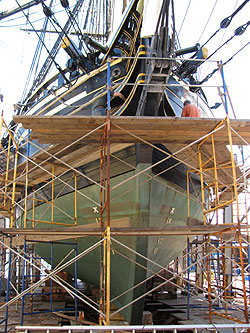 Friendship up on a drydock, surrounded by scaffolding.