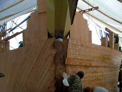 View of the bow of the ship showing new planking on the hull.