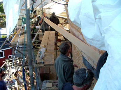 Planking is dampened, fitted in place to match the curve of the hull, and fastened