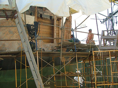 removing damaged wood from the bow of Friendship