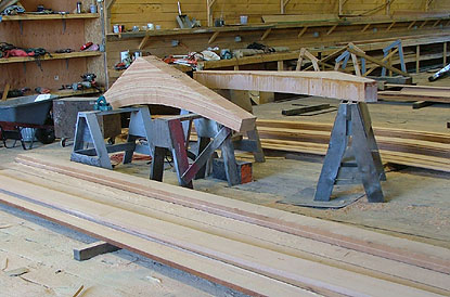strips of wood are glued into an arc that will later be shaped like a shelf bracket to support the deck.