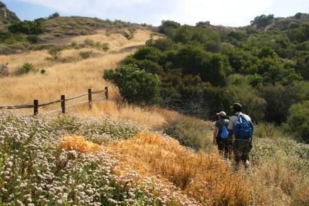 Two visitors enjoy the hiking the Backbone Trail through the Eastern end of the Santa Monica Mountains.