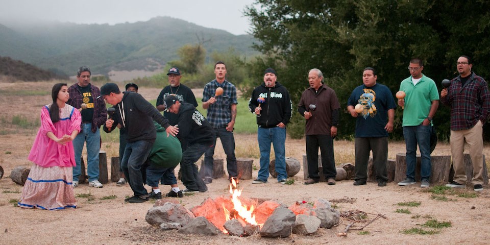 Chumash singers enjoying traditional song and dance by campfire at Rancho Sierra Vista