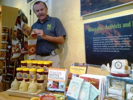 Volunteer John Millraney displays items for sale in the visitor center store.