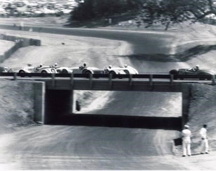 Race cars travel over the "bridge" at Paramount Ranch racetrack in the mid 1950's.
