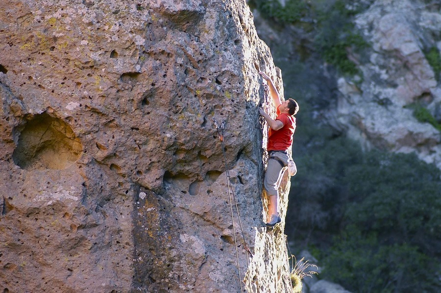 A male rock climbs