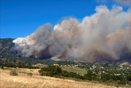 This fire is driven by steep topography, dry vegetation, and fast winds.