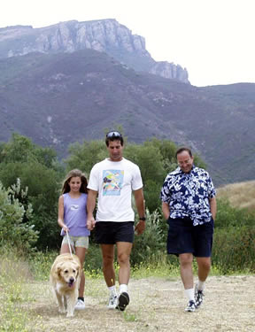 Family hikes with dog on a trail near Satwiwa.